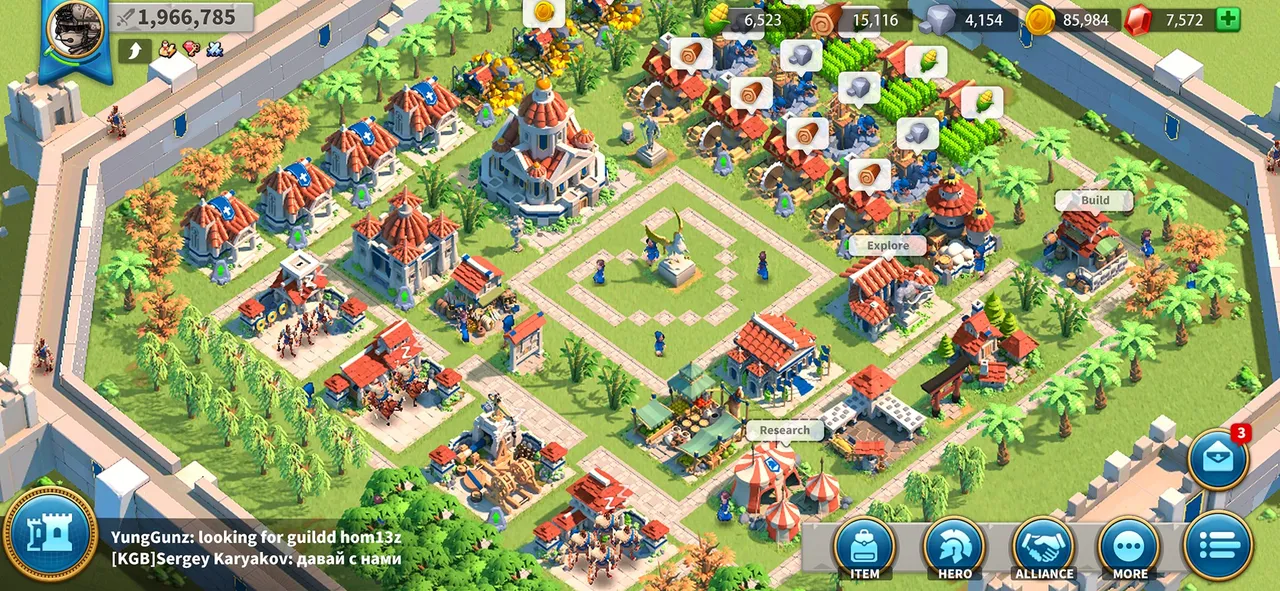 Walled city with red-roofed buildings, farms and a central plaza seen from above in Rise of Kingdoms